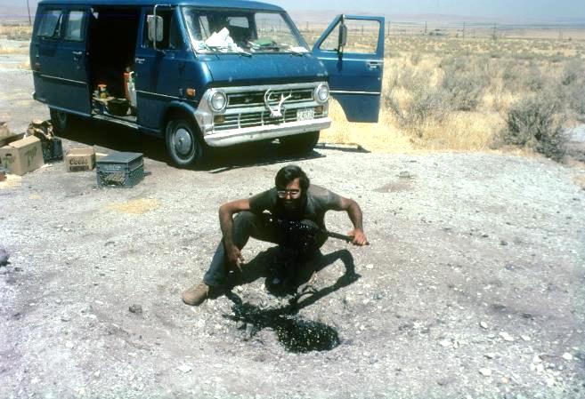 George at our camp site near Taft, CA in August 1983. My van Betsy in back. An active tar seep in the foreground