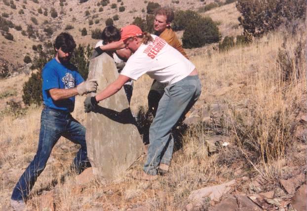 Jon, Maurizio (obscured), Mike, and Clayton rolling one of the larger pieces to the van.